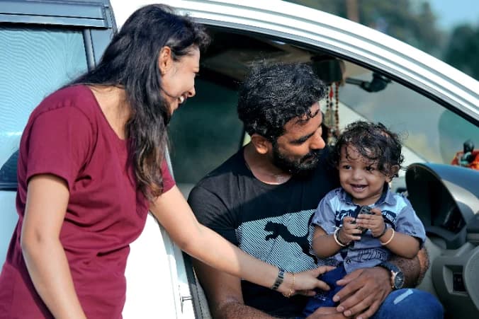 Young family by a car